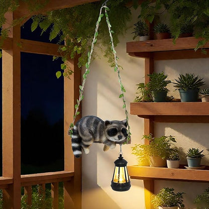 Solar Lighted Garden Outdoor Statue, 20.1" H Hanging Swing Lying with A Sleeping Raccoon and A LED Lantern, Resin Animal Figurine Hanging Ornaments with Hook for Decoration & Gift