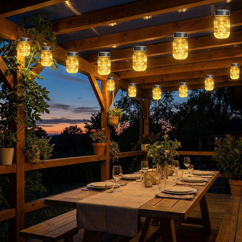 12-pack outdoor string lights glowing at dusk over an outdoor dining table